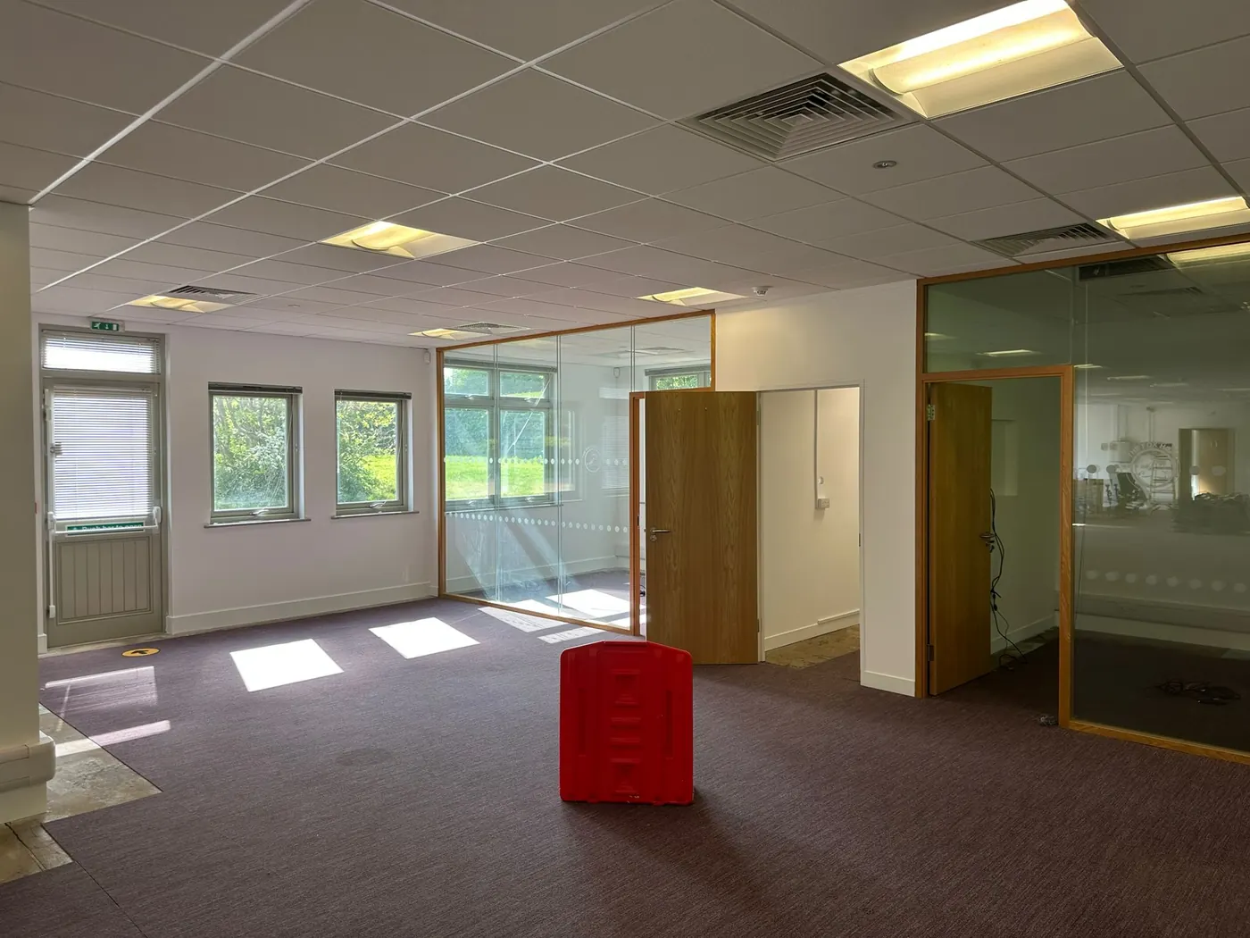 Freshly redecorated open-plan office space with crisp white walls and ceiling, painted by Martin And Co. Decorating